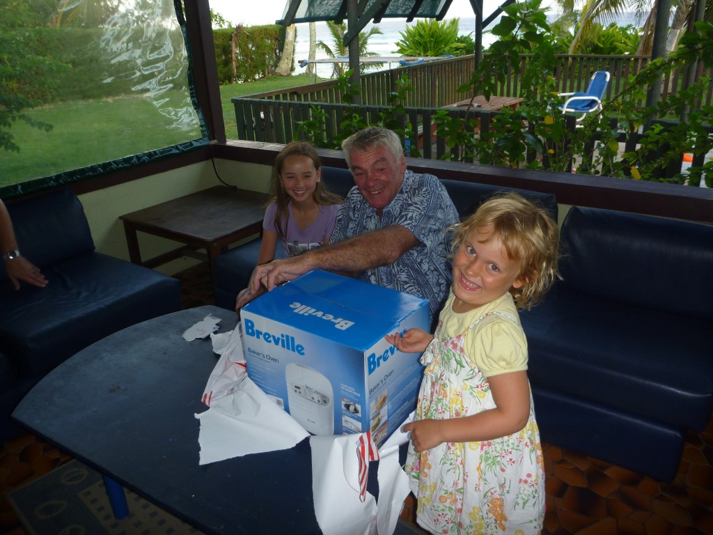 Amelia being at least as excited as Papa M. with the present being opened.